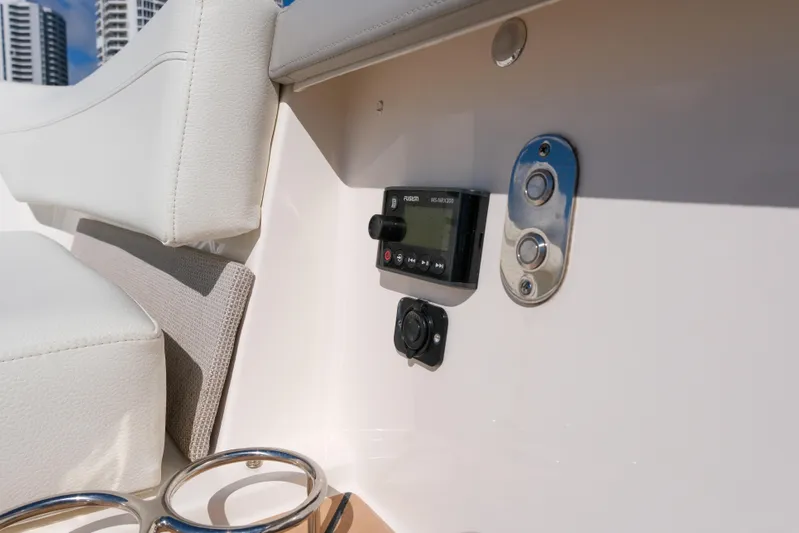Feeling Knotty Yacht Photos Pics 2023 Tiara Yachts 48 LS interior detail with control panel and cup holders.