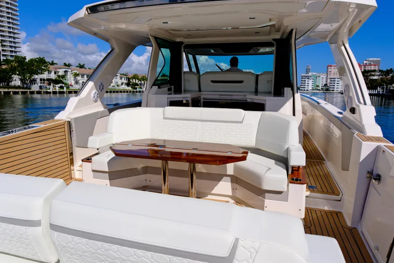 Feeling Knotty Yacht Photos Pics 2023 Tiara Yachts 48 LS luxury yacht interior with elegant seating and wooden table.