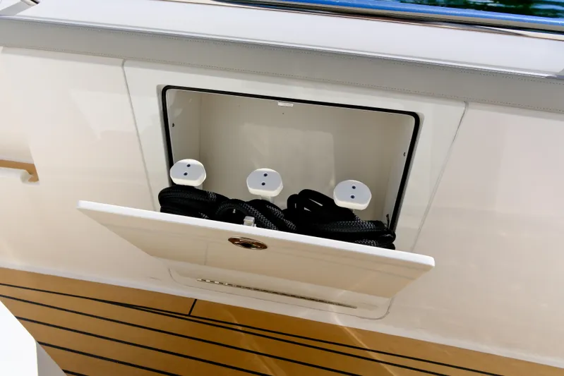 Feeling Knotty Yacht Photos Pics Storage compartment on 2023 Tiara Yachts 48 LS, featuring sleek design and practical functionality.