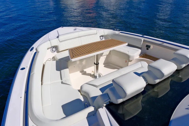 Feeling Knotty Yacht Photos Pics 2023 Tiara Yachts 48 LS boat interior with seating and table on calm water.