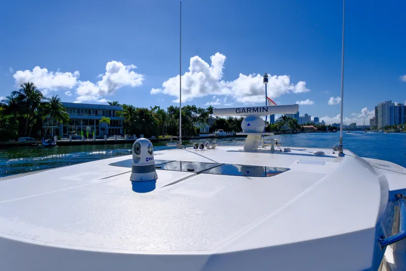 Feeling Knotty Yacht Photos Pics 2023 Tiara Yachts 48 LS cruising on a sunny waterway with clear skies.