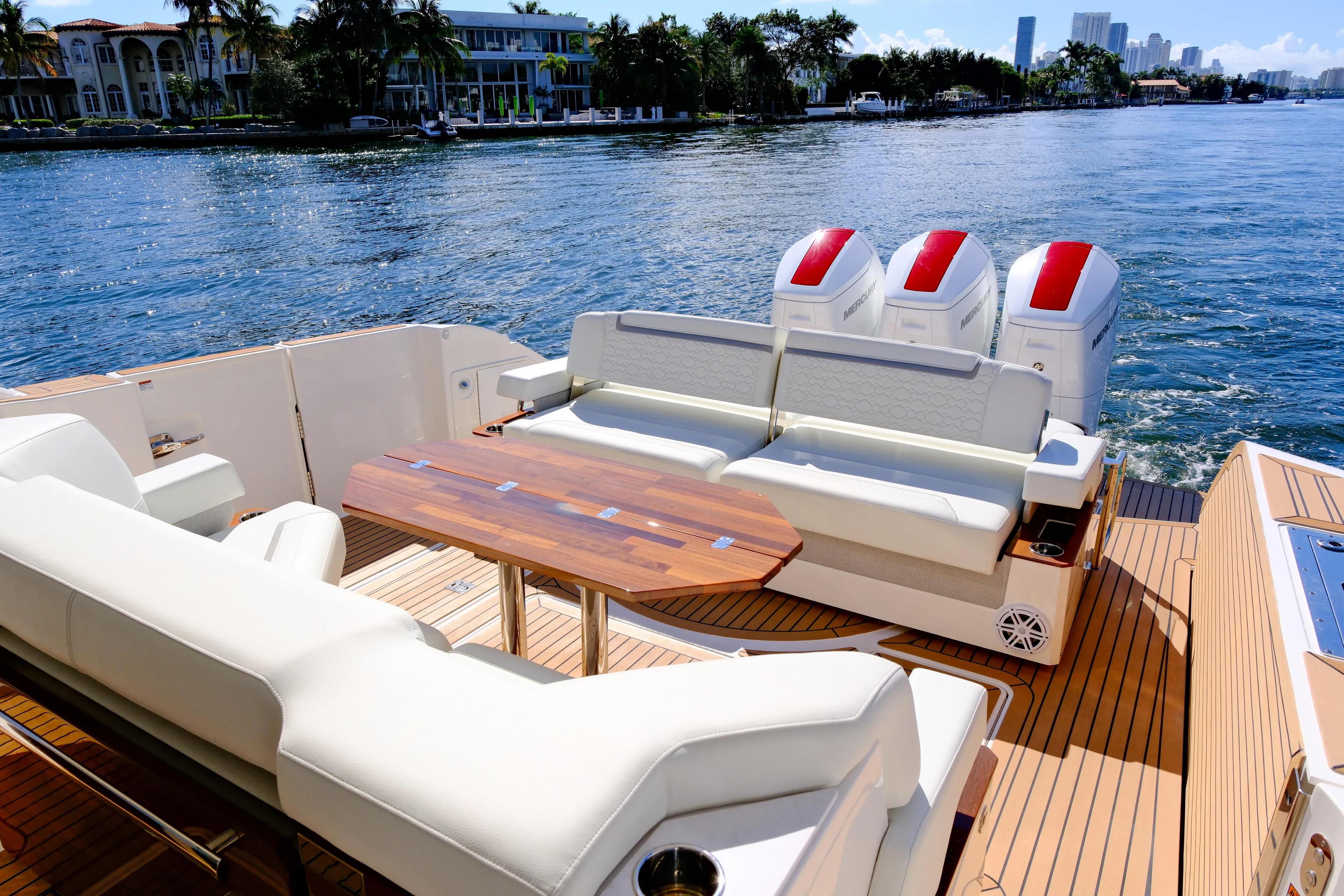Feeling Knotty Yacht Photos Pics 2023 Tiara Yachts 48 LS luxury boat with spacious deck and seating, cruising on a sunny day.