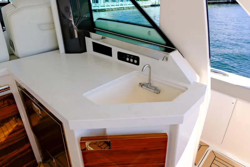 Feeling Knotty Yacht Photos Pics 2023 Tiara Yachts 48 LS interior with sleek countertop and sink, overlooking water.