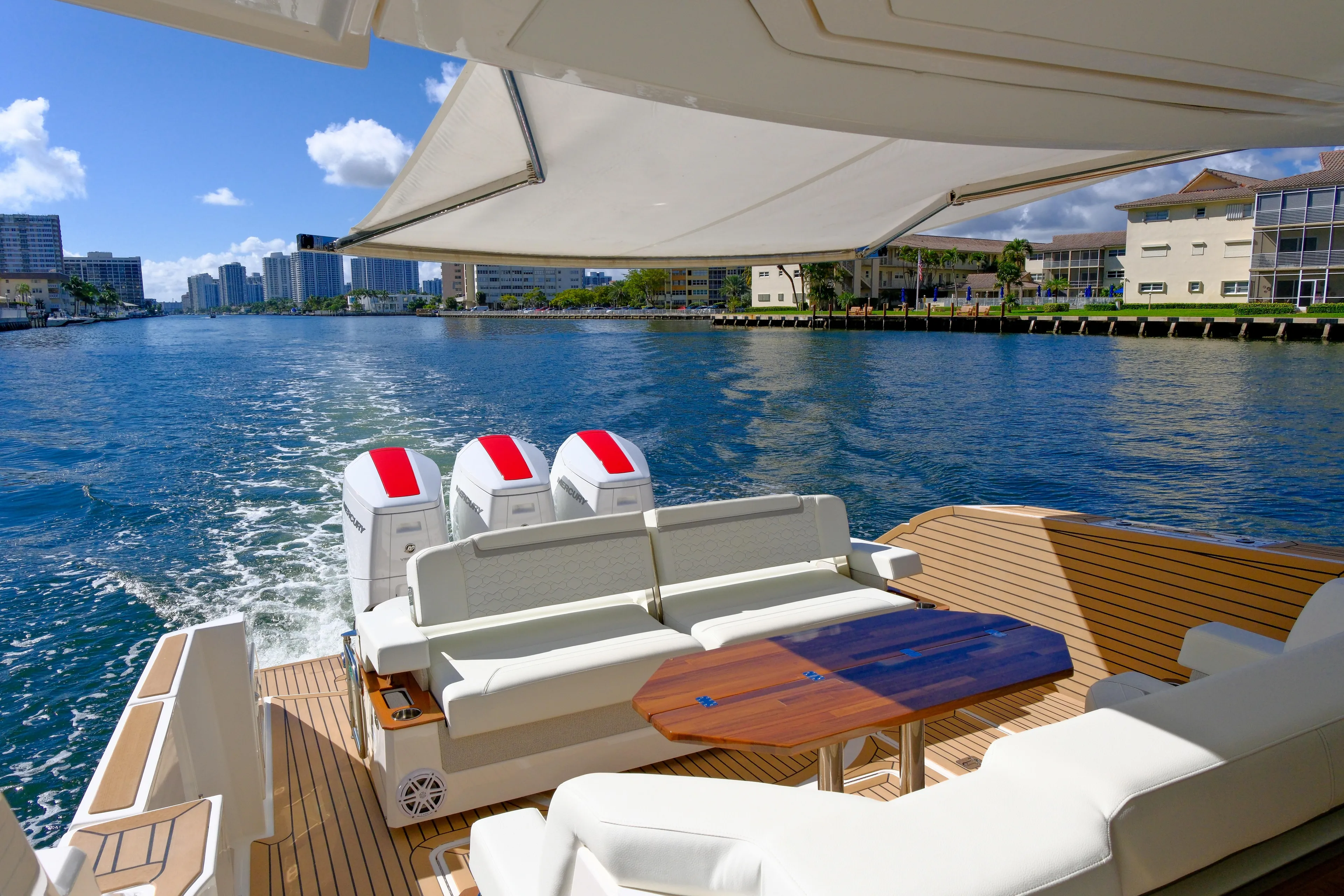 Feeling Knotty Yacht Photos Pics 2023 Tiara Yachts 48 LS cruising on a sunny day, featuring luxurious seating and powerful engines.