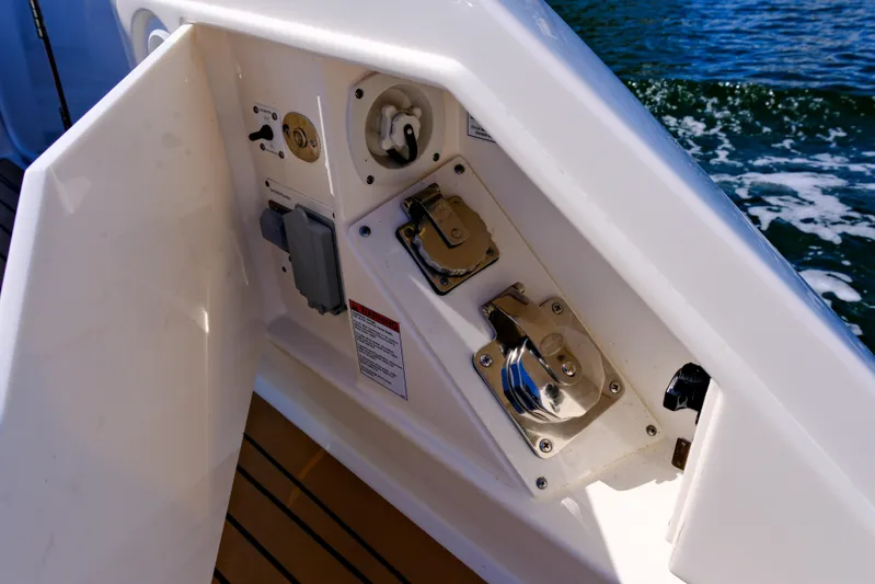 Feeling Knotty Yacht Photos Pics 2023 Tiara Yachts 48 LS yacht deck controls with ocean backdrop.
