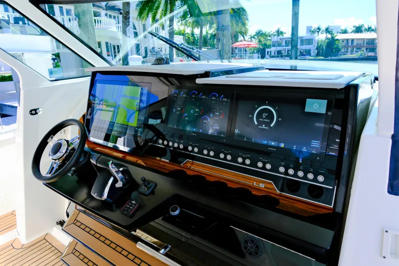Feeling Knotty Yacht Photos Pics 2023 Tiara Yachts 48 LS helm with advanced navigation displays and controls.