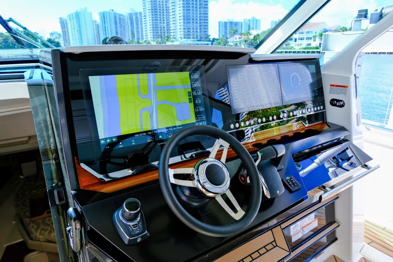 Feeling Knotty Yacht Photos Pics 2023 Tiara Yachts 48 LS helm with advanced navigation displays and controls.