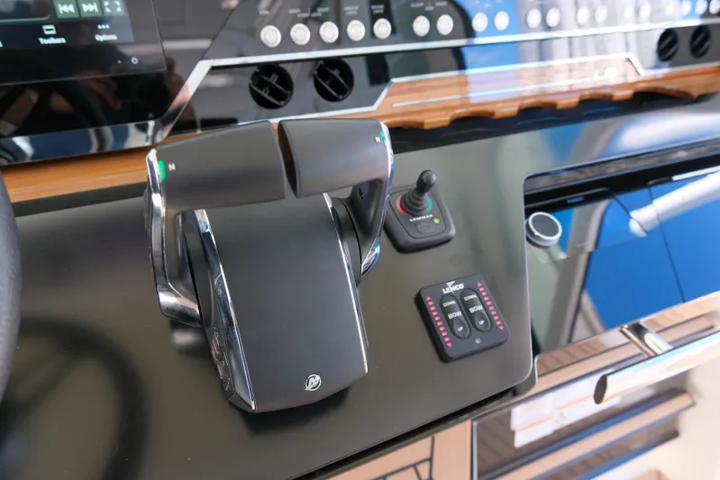 Feeling Knotty Yacht Photos Pics Control panel of 2023 Tiara Yachts 48 LS, featuring throttle and joystick controls.