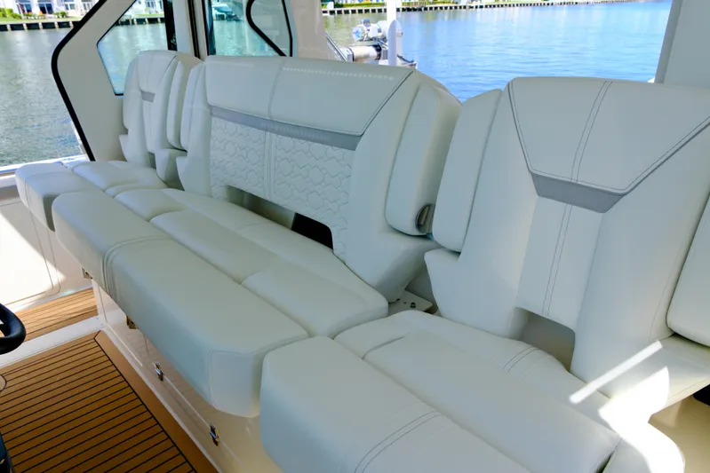 Feeling Knotty Yacht Photos Pics Luxurious seating on 2023 Tiara Yachts 48 LS, featuring elegant white upholstery.