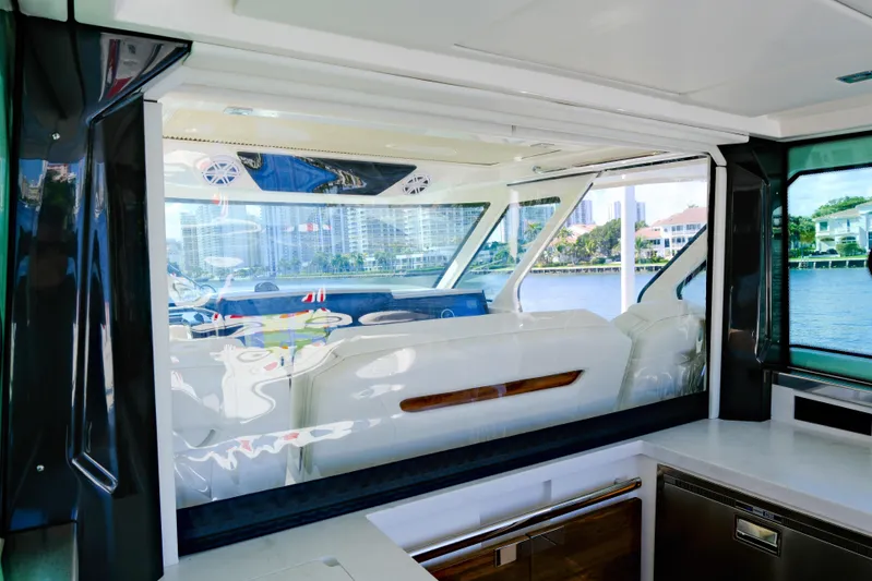 Feeling Knotty Yacht Photos Pics 2023 Tiara Yachts 48 LS interior with luxurious seating and waterfront view.