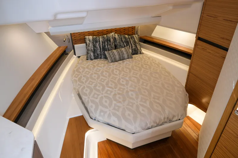Feeling Knotty Yacht Photos Pics Luxurious cabin interior of 2023 Tiara Yachts 48 LS with elegant bedding and wood accents.