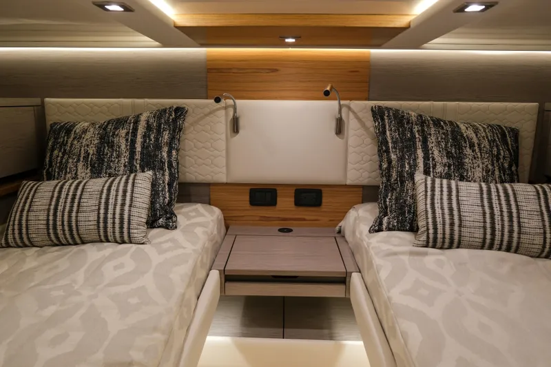 Feeling Knotty Yacht Photos Pics Luxurious 2023 Tiara Yachts 48 LS cabin with twin beds and elegant decor.