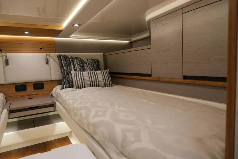 Feeling Knotty Yacht Photos Pics Luxurious cabin interior of 2023 Tiara Yachts 48 LS with modern bedding and ambient lighting.