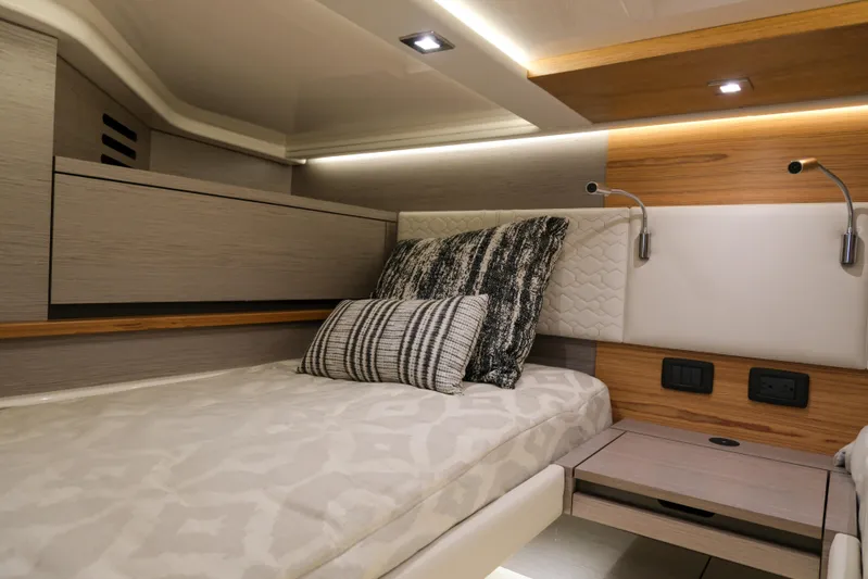 Feeling Knotty Yacht Photos Pics Luxurious cabin interior of 2023 Tiara Yachts 48 LS with modern design and cozy bedding.