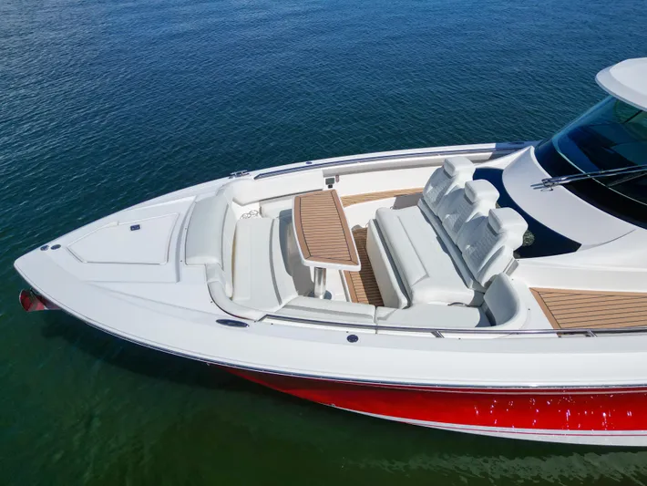Feeling Knotty Yacht Photos Pics 2023 Tiara Yachts 48 LS with sleek design and spacious seating on calm water.