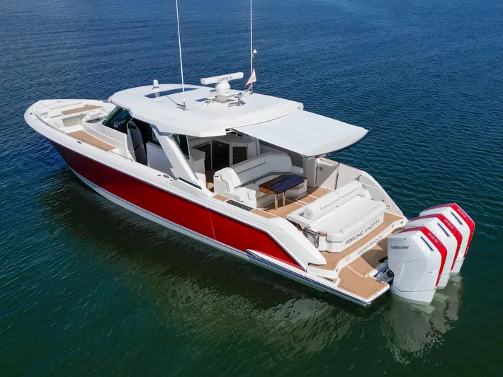 Feeling Knotty Yacht Photos Pics 2023 Tiara Yachts 48 LS in water, featuring sleek design and powerful outboard engines.