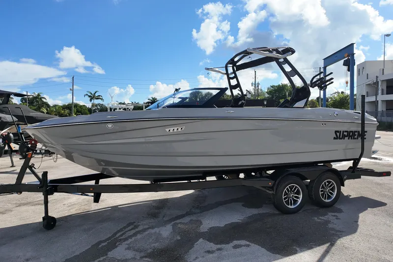  Yacht Photos Pics 2025 Supreme S220 boat on trailer under clear blue sky.