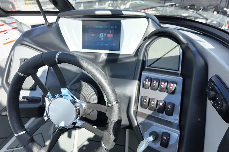  Yacht Photos Pics 2025 Supreme S220 boat dashboard with steering wheel and control panel.