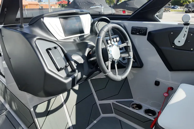  Yacht Photos Pics Interior of 2025 Supreme S220 boat, featuring modern steering wheel and dashboard controls.