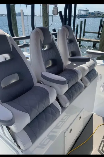 Necessity Yacht Photos Pics Luxury seating on a 2018 Freeman 42LR boat, docked by the water.