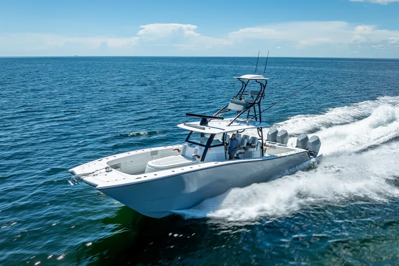  Yacht Photos Pics 2024 Freeman 43 boat cruising on open ocean under clear blue sky.