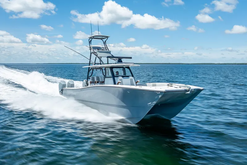  Yacht Photos Pics 2024 Freeman 43 boat cruising on open water under a clear blue sky.