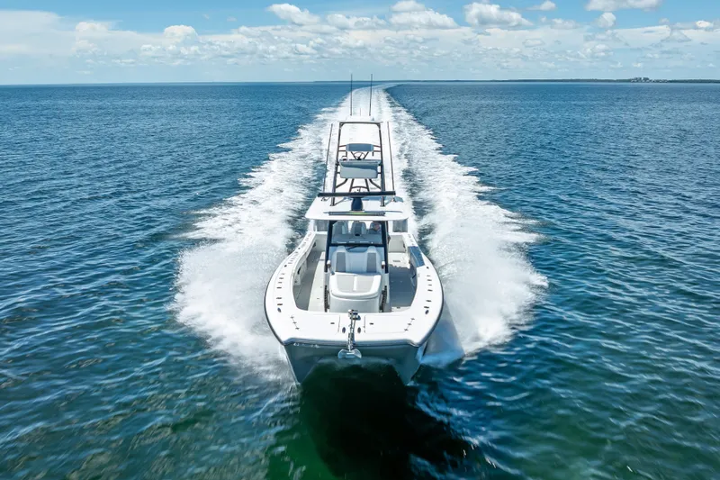  Yacht Photos Pics 2024 Freeman 43 boat cruising on open water under a clear blue sky.