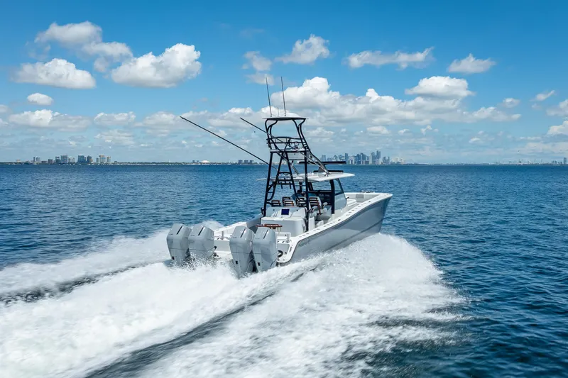  Yacht Photos Pics 2024 Freeman 43 boat cruising on open water with city skyline in background.