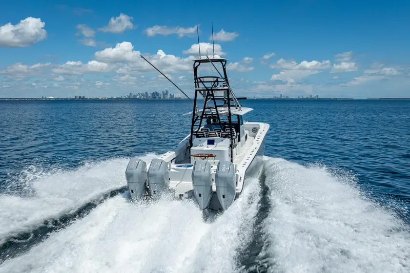  Yacht Photos Pics 2024 Freeman 43 boat cruising on open water with city skyline in background.