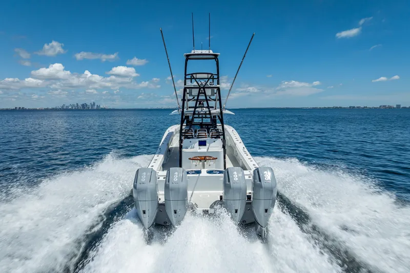  Yacht Photos Pics 2024 Freeman 43 boat cruising on open water with city skyline in background.