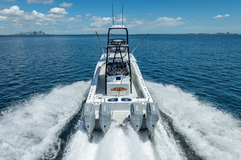  Yacht Photos Pics 2024 Freeman 43 boat cruising on open water with city skyline in background.