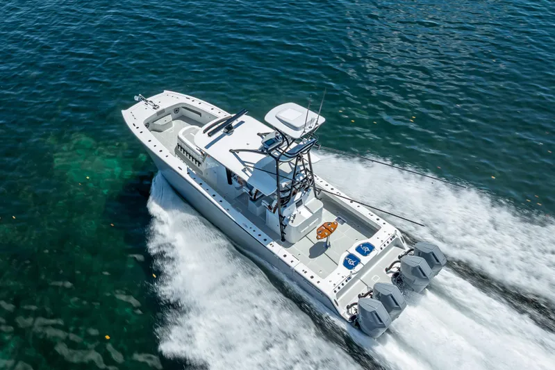  Yacht Photos Pics 2024 Freeman 43 boat cruising on clear blue water, showcasing powerful engines.