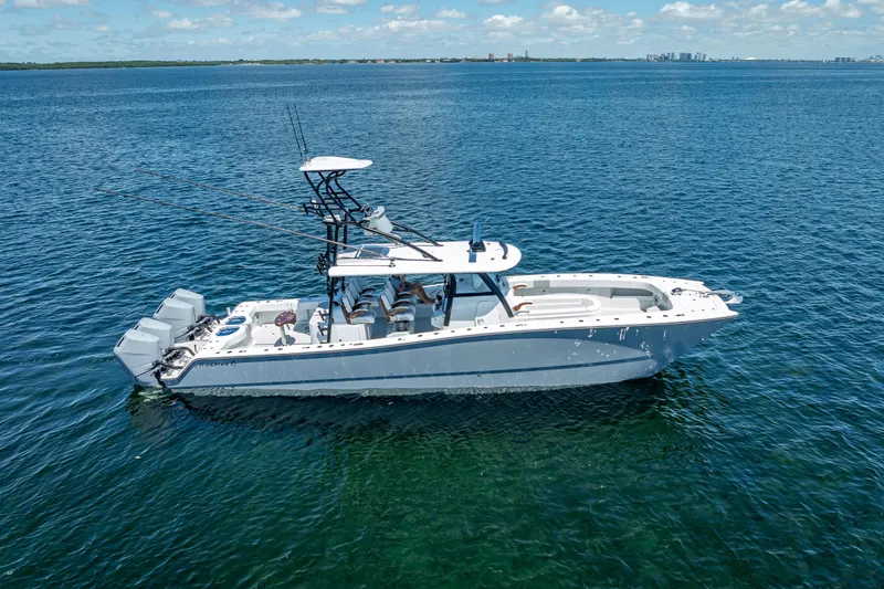  Yacht Photos Pics 2024 Freeman 43 boat on open water, featuring multiple outboard engines and fishing rods.