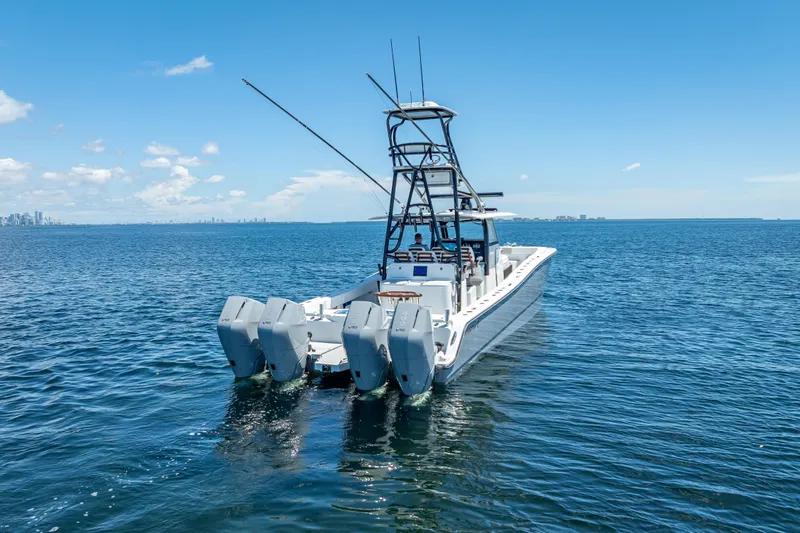  Yacht Photos Pics 2024 Freeman 43 boat with multiple engines on open water under clear blue sky.