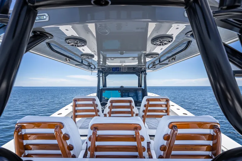  Yacht Photos Pics 2024 Freeman 43 boat interior with wooden seats, ocean view, and modern design.