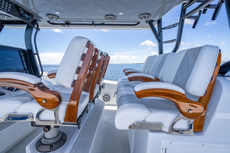  Yacht Photos Pics Luxurious seating on 2024 Freeman 43 boat, featuring elegant wood and leather design.