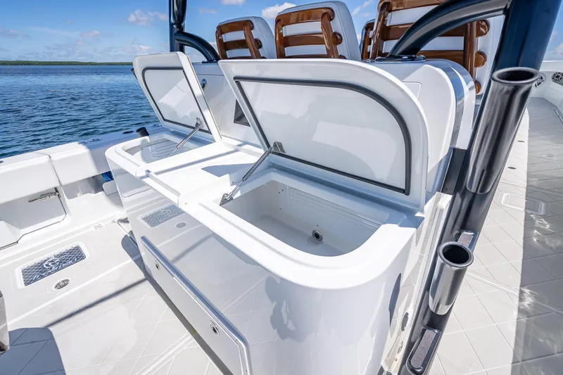  Yacht Photos Pics 2024 Freeman 43 boat with open storage compartments on deck, ocean view.