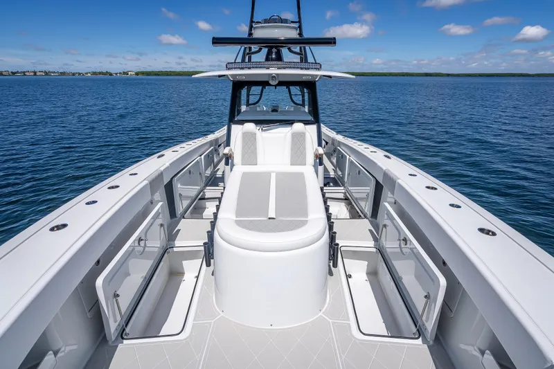  Yacht Photos Pics 2024 Freeman 43 boat deck with open storage, on calm blue water under clear sky.