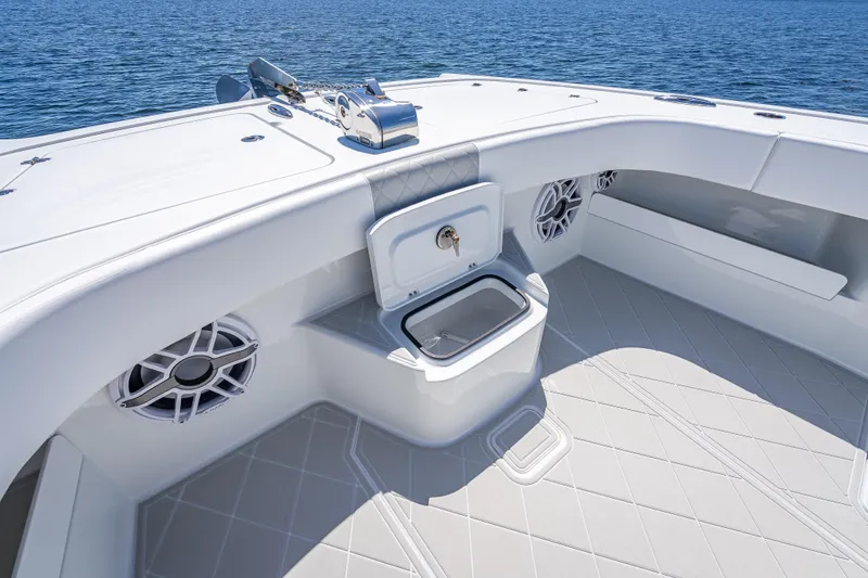  Yacht Photos Pics 2024 Freeman 43 boat deck with storage compartment and speakers, on calm blue water.