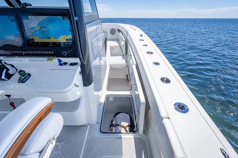  Yacht Photos Pics 2024 Freeman 43 boat interior with navigation screens, storage compartments, and ocean view.
