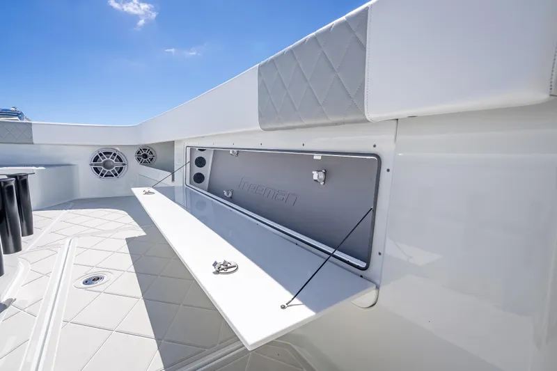 Yacht Photos Pics 2024 Freeman 43 boat interior with storage compartment and speakers, under clear blue sky.