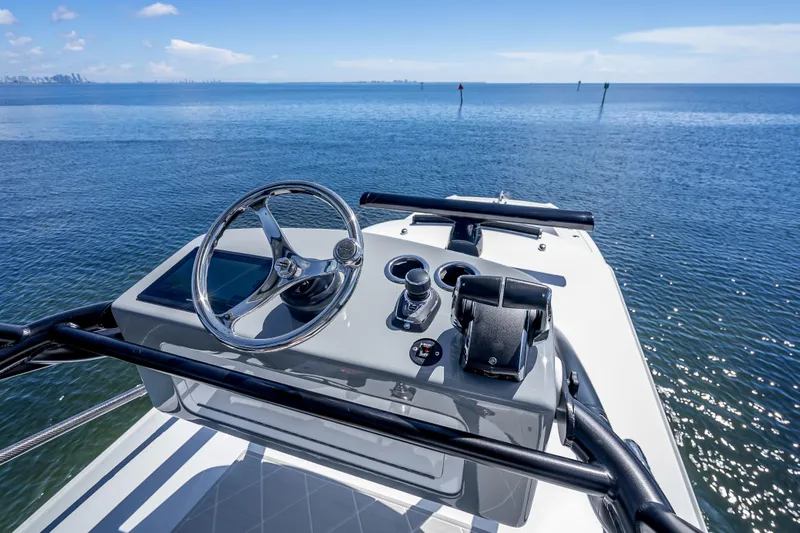  Yacht Photos Pics 2024 Freeman 43 boat helm with ocean view, featuring steering wheel and controls.