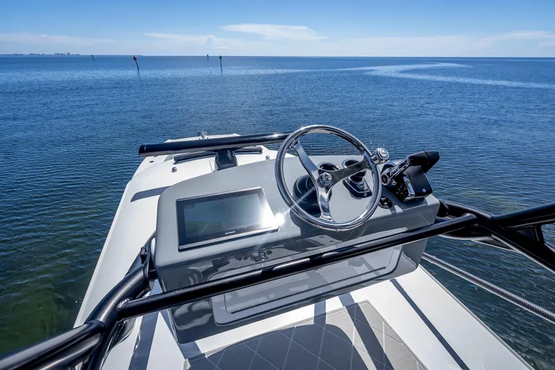  Yacht Photos Pics 2024 Freeman 43 boat helm with steering wheel and navigation system on open water.