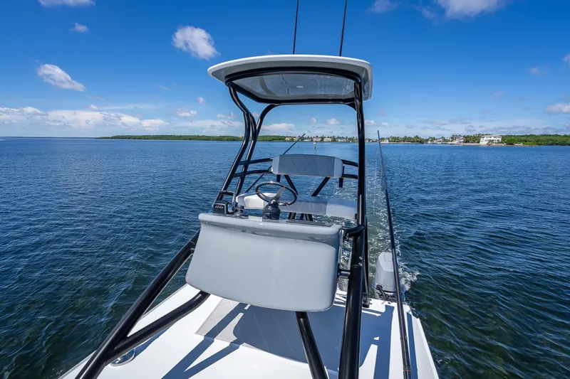  Yacht Photos Pics 2024 Freeman 43 boat navigating calm waters under a clear blue sky.