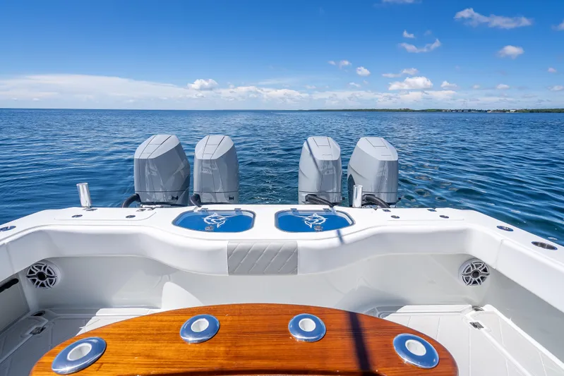  Yacht Photos Pics 2024 Freeman 43 boat with four engines on open water under clear blue sky.