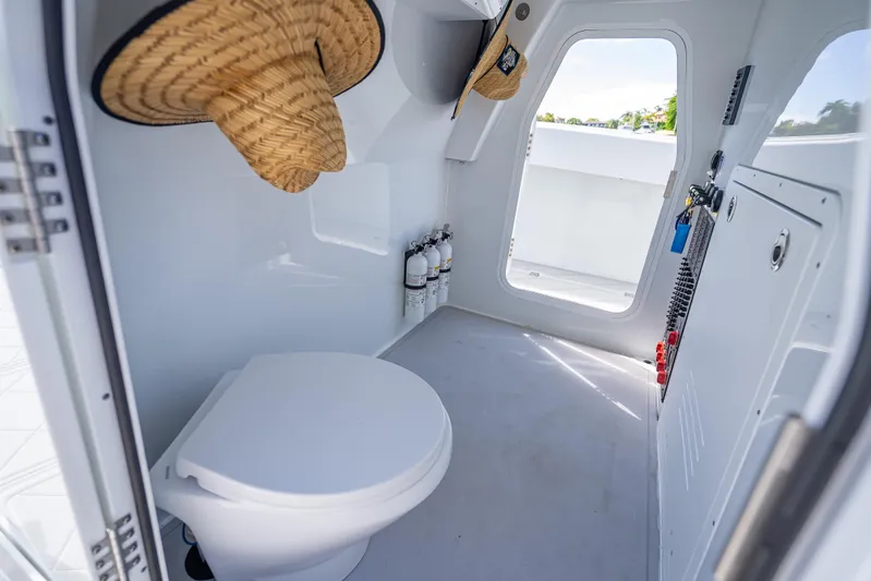  Yacht Photos Pics 2024 Freeman 43 boat interior with toilet, fire extinguishers, and straw hats.