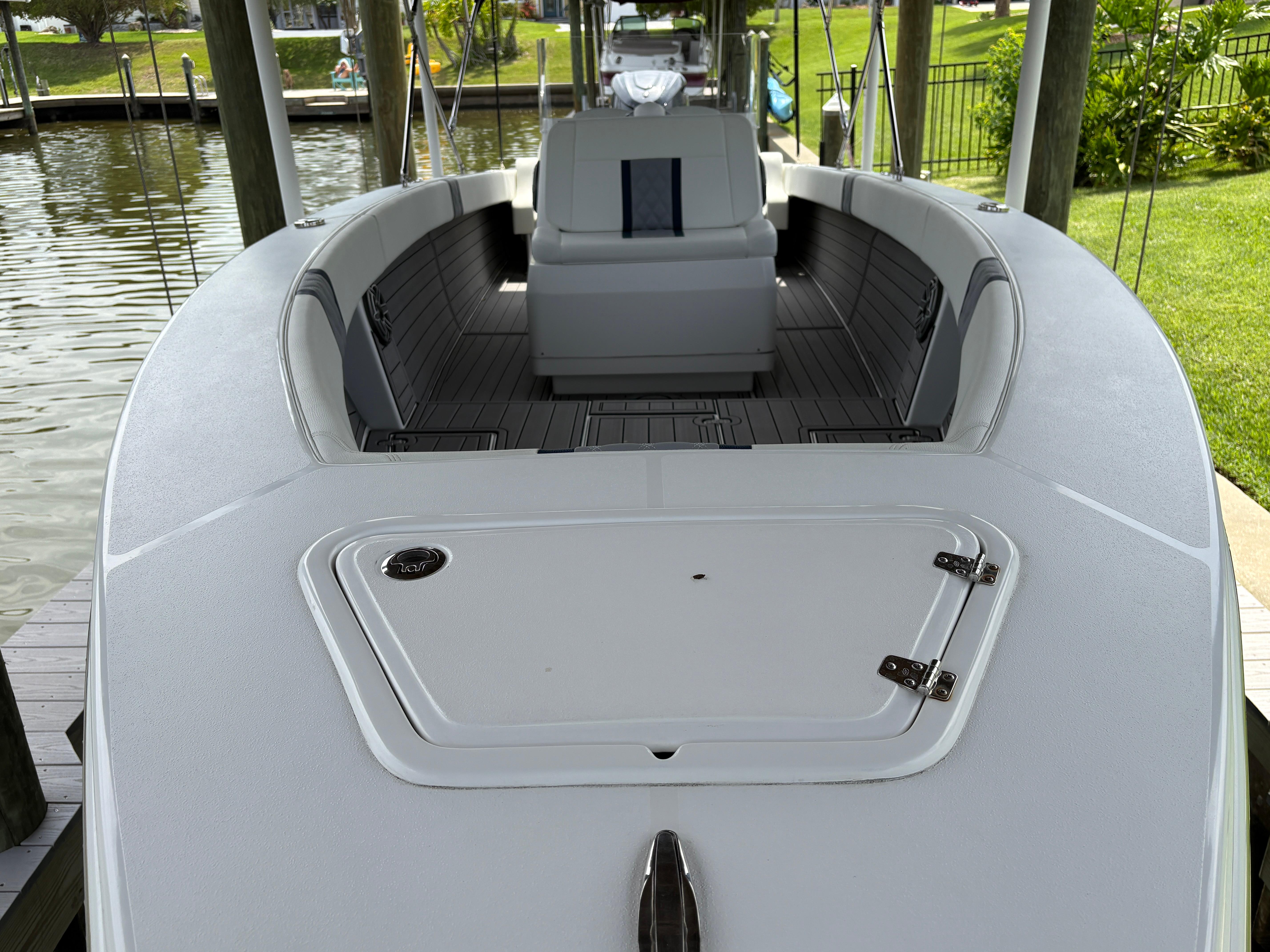 Modern Action 25 boat docked, showcasing sleek design and spacious interior, 2023 model.
