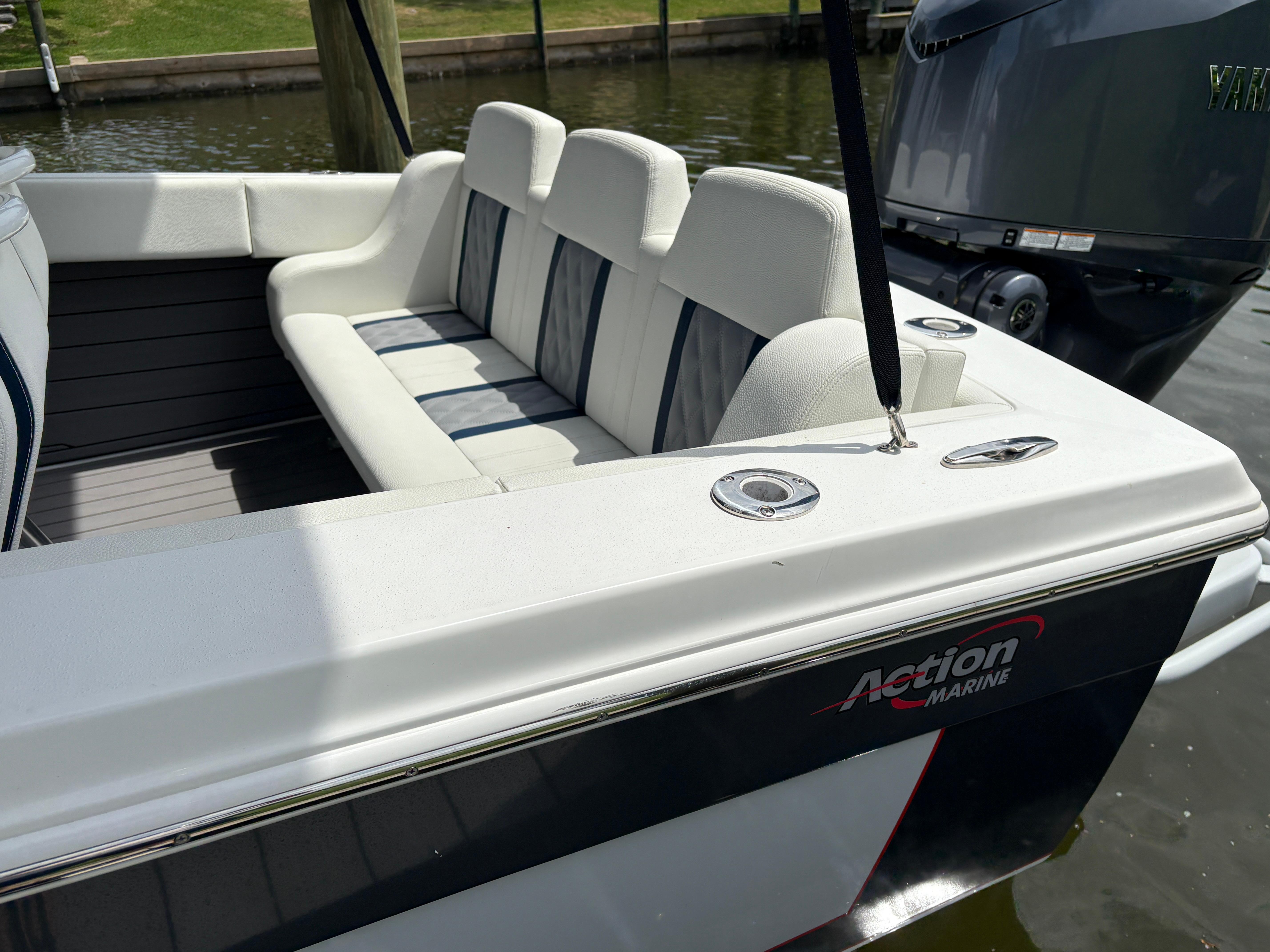 2023 Action 25 boat with white seating and Yamaha outboard motor.
