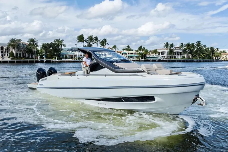  Yacht Photos Pics 2025 SACS 40 Rebel boat cruising on a scenic waterway with palm trees.