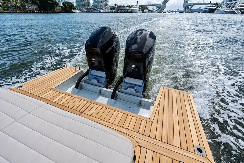  Yacht Photos Pics 2025 SACS 40 Rebel boat with twin Mercury engines on a wooden deck.